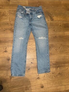 Levi's 501 high-rise blue denim jeans with distressed detailing